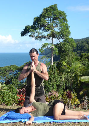 Outdoor hand-warming Thai yoga massage position